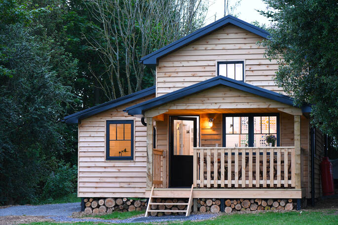 Exterior of cosy Walden Lodge cabin at Hide at St Donats in Vale of Glamorgan