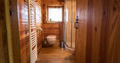 Bathroom with shower and flushing toilet at Gauthie Treehouse Cabin, Dordogne, France
