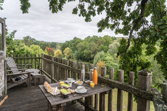 Enjoy breakfast on the terrace at Gauthie Treehouse Cabin, Dordogne, France