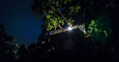 Gauthie Treehouse Cabin lit up at night Dordogne, France
