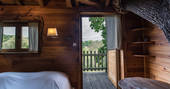 Tree growing through the bedroom at Gauthie Treehouse Cabin, Dordogne, France