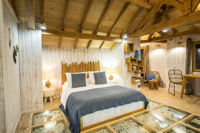 Luxurious double bed at Chateau Biron, Châteaux dans les Arbres, Dordogne, France