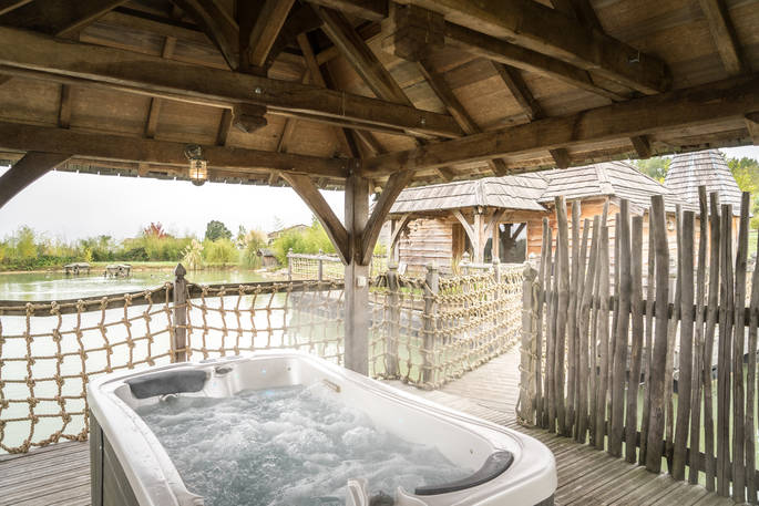 Private hot tub on the terrace at Chateau Biron, Châteaux dans les Arbres, Dordogne, France