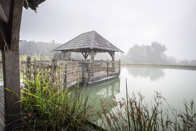View of the lake from the terrace at Chateau Biron, Châteaux dans les Arbres, Dordogne, France