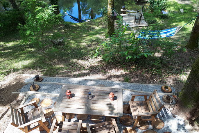 Settle in and relax on the decking at Woodman's Cabin in Dordogne, France