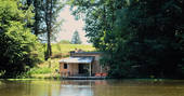 GoGreen cabin on its private lake nestled in between the trees at Dordogne in France 