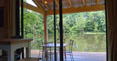 View of the private lake from inside the patio doors of GoGreen cabin