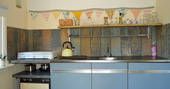 Kitchen area inside of GoGreen Roulotte with quirky shelf and bunting 
