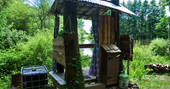 The outdoor shower hut, overlooking the lake at GoGreen Roulette in Dordogne, France