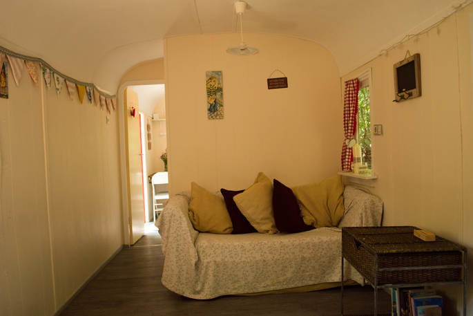 Living area inside the Roulotte with bunting around the walls