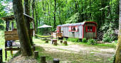 A view of the GoGreen Roulette with two covered dining areas and a hammock in Dordogne, France