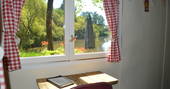 Seating area inside GoGreen Roulotte looking out on the gorgeous lake outside 