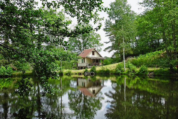 A view of Poacher's Cabin across the lake in Dordogne, France