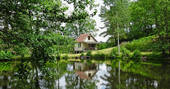 A view of Poacher's Cabin across the lake in Dordogne, France