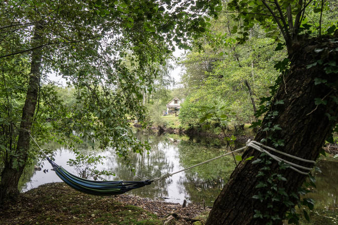 Sit in a hammock with views of Poacher's Cabin in Dordogne, France