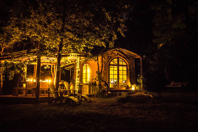 Elvensong Cabin lit up at night in Dordogne, France