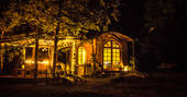 Elvensong Cabin lit up at night in Dordogne, France