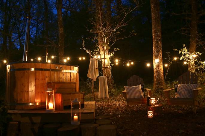 Sky Light treehouse hot tub at night time with fairy lights, Terre et Toi, Dordogne, France