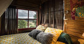 Comfy canopy bed with views over the lake at Layenie Under The Stars