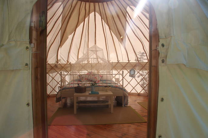 Double bed interior at Cherry Blossom Yurt, Haute-Loire