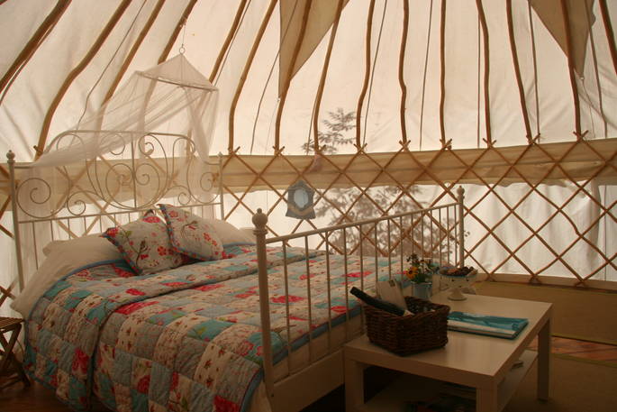 Double bed interior at Cherry Blossom Yurt, Haute-Loire