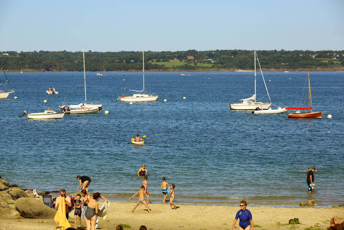 Boats on the sea and people on the beach at Bot-Conan in France