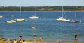 Boats on the sea and people on the beach at Bot-Conan in France