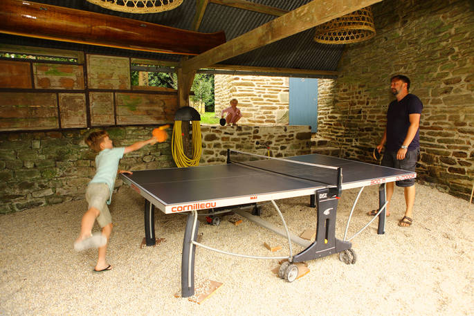 Guests playing ping pong at Bot-Conan Lodge in France