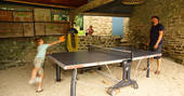 Guests playing ping pong at Bot-Conan Lodge in France