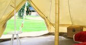 Interior of Atoll bell tent looking out at the rest of Bot-Conan Lodge in France