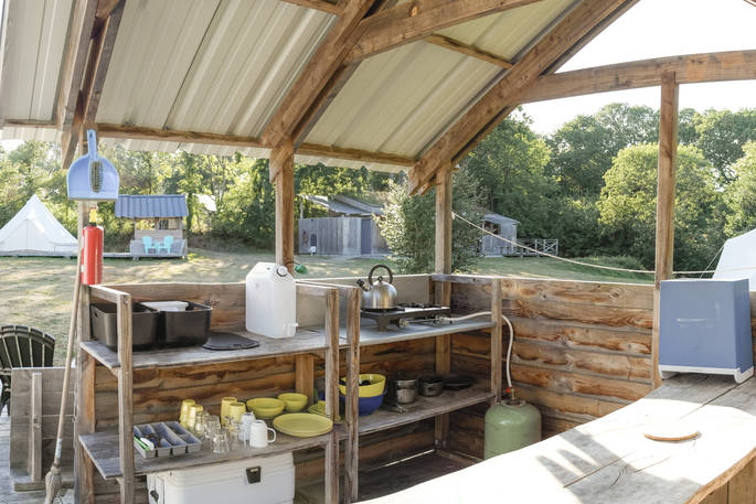 Kitchen facilities on the wooden decking outside of the safari tents in France