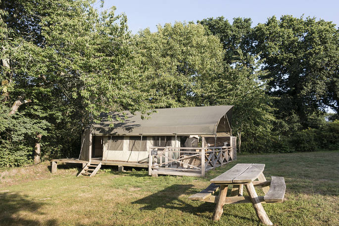 Exterior of Bananec Lodge Tent and wooden bench outside at Bot-Conan Lodge