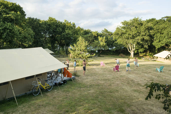 Hang outside of Bananec Lodge Tent and play games in the field at Bot-Conan Lodge in France