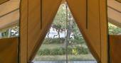 Opening doors to Bananec Lodge Tent at Bot-Conan Lodge in France