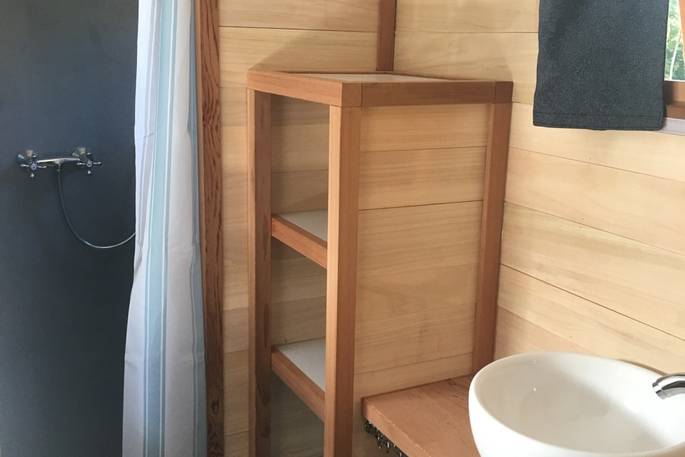 Close up of the wooden shelves inside the bathroom at La Cabane de Bot-Conan in France