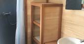 Close up of the wooden shelves inside the bathroom at La Cabane de Bot-Conan in France