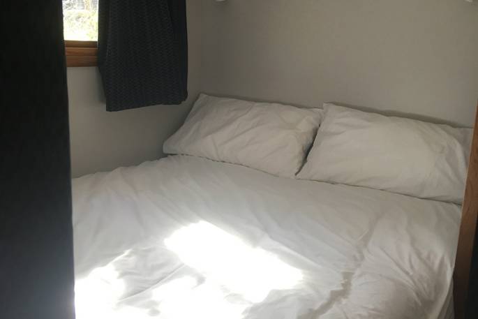 Double bed inside of La Cabane de Bot-Conan in France