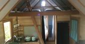 Inside of La Cabane de Bot-Conan with two single beds on mezzanine leave above the kitchen facilities