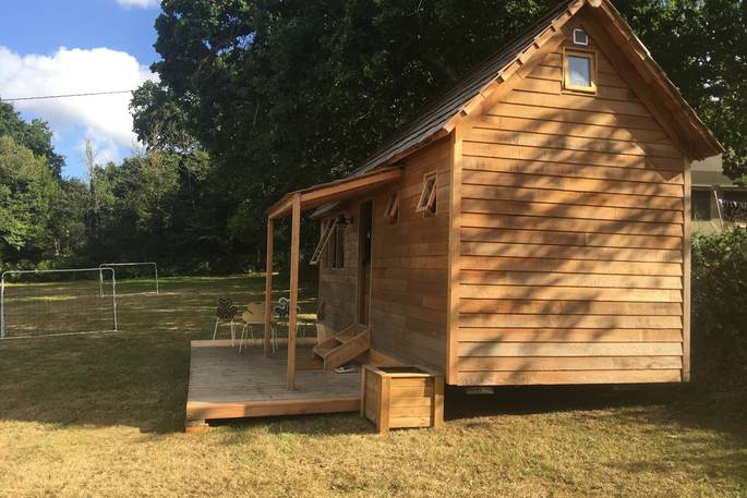 Side view of La Cabane de Bot-Conan in the fields of Bot-Conan Lodge, France