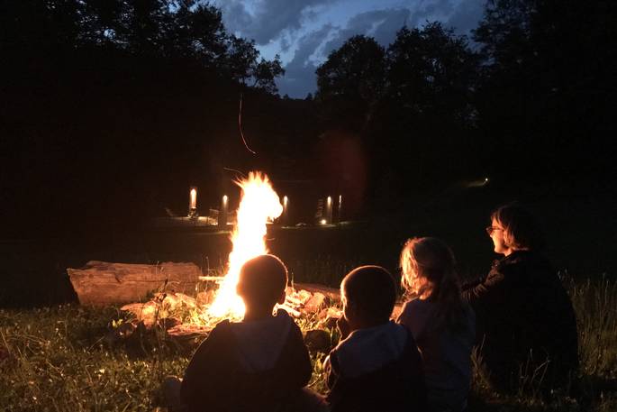 Sitting around the campfire at Cabane de Salagnac Cèdre Gris, Corrèze, France