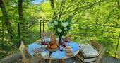 Enjoy breakfast on the terrace at Cabane de Salagnac Cèdre Blanc Tree Cabin in Corrèze, France