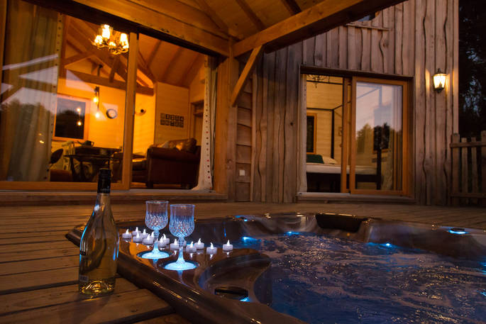 Soak in the outdoor hot tub at night with a glass of champagne at Sommet de Memanat in France