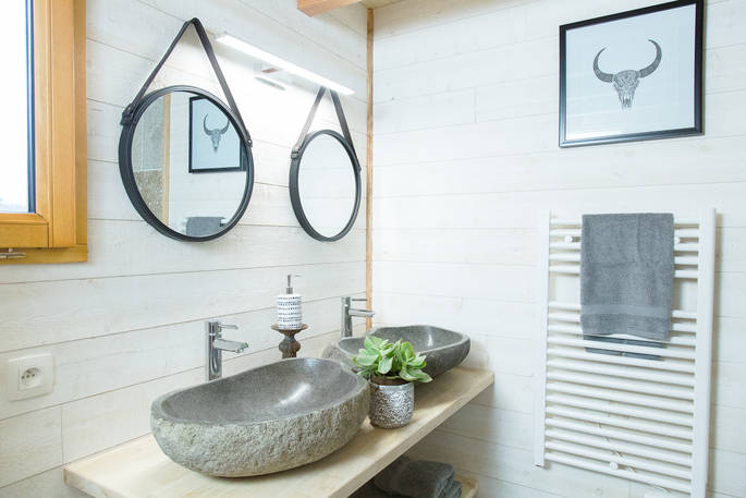 Twin stone sinks in the bathroom of Sommet de Memanat treehouse in France