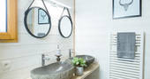 Twin stone sinks in the bathroom of Sommet de Memanat treehouse in France