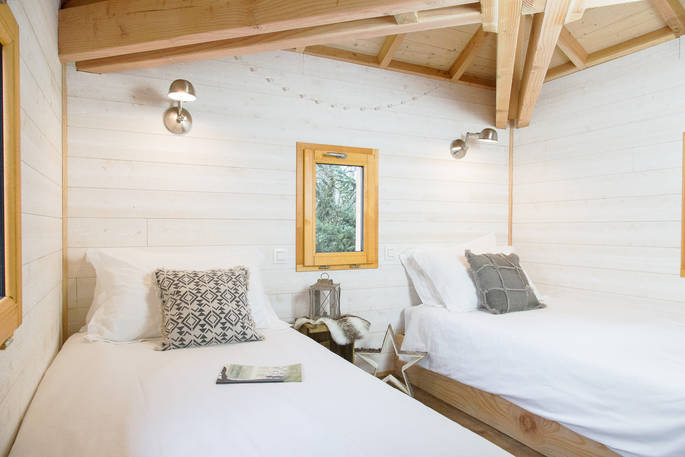 Two single beds in the turret accessed by a ladder at Sommet de Memanat treehouse in Limousin 