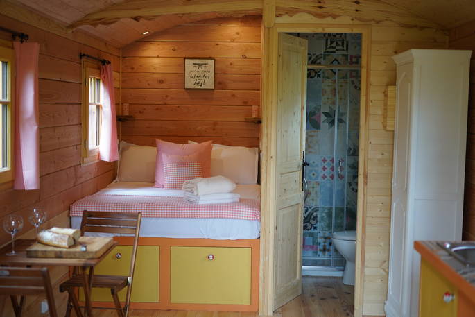 Beatrice roulotte shepherd's hut interior living space with en suite bathroom at Coutillard in France 