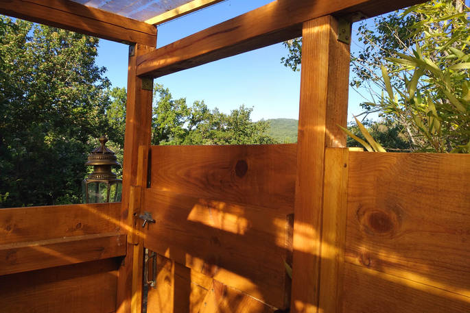 Outdoor wooden private shower for Mount Kenya guests at Le Camp in France