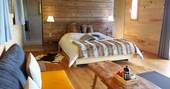 The quirky and cosy interior of La Grande Cabane du Perche, with comfortable double bed