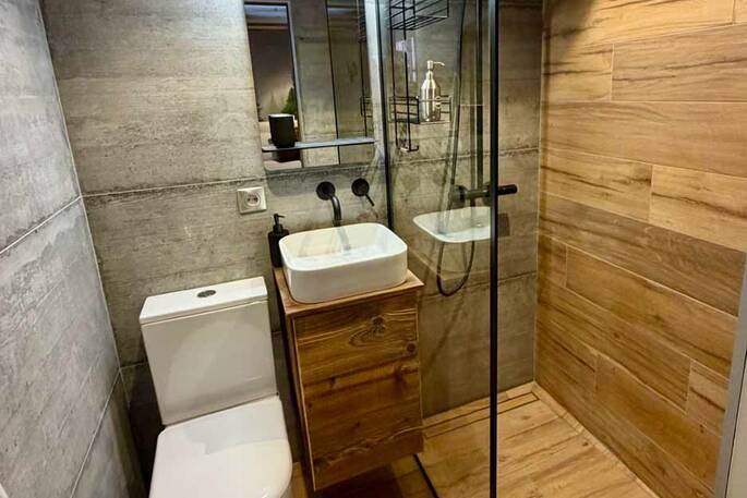Bathroom with a hot shower, sink and flushing toilet