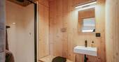 Bathroom with a hot shower, compost loo, and sink